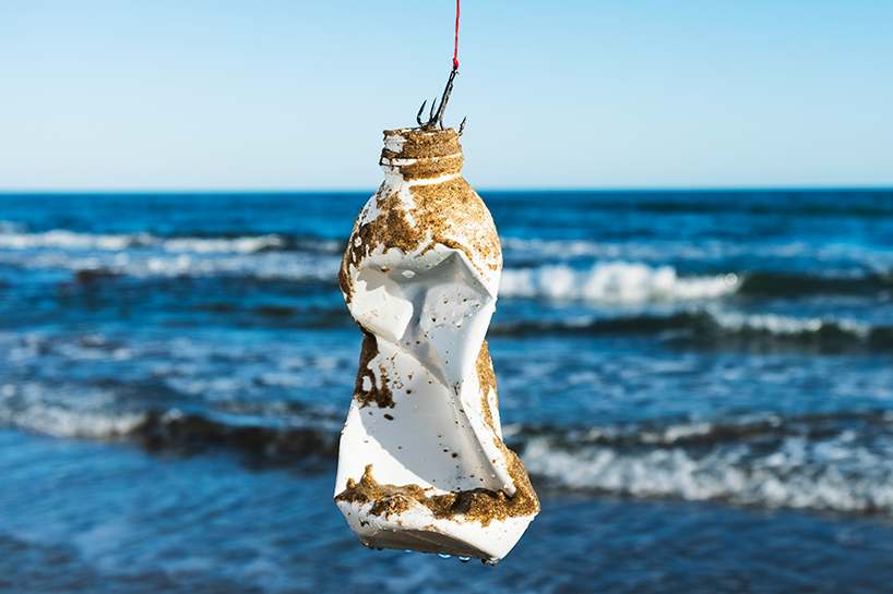 Plastic bottle dangling on a fishing hook